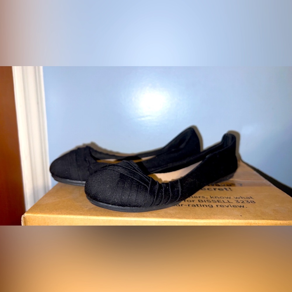 Never worn before. Black flats with design on toe.